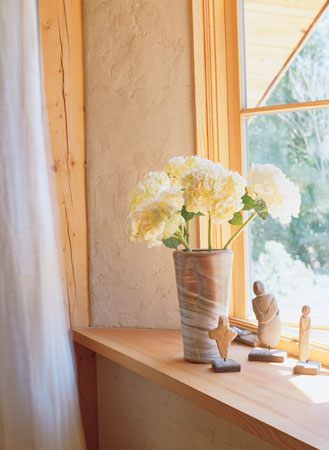 
Straw-clay walls are one foot thick, providing lots of insulation and adding to the cozy, cavelike ambience.
